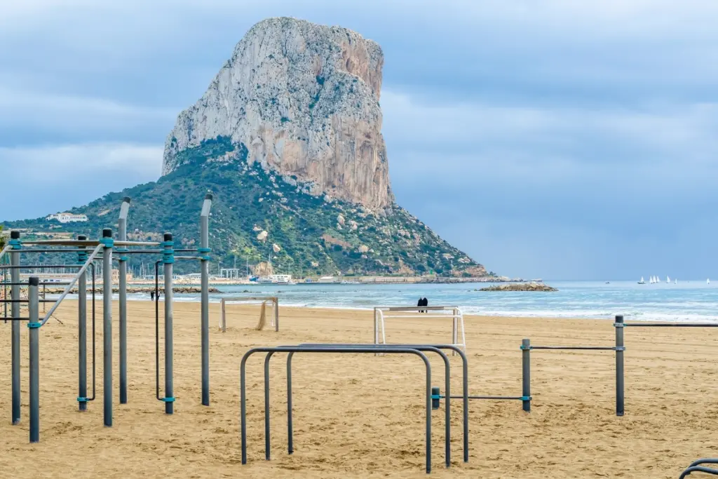Outdoor fitness equipment on Arenal Bol Beach in Calpe with the Peñón de Ifach behind