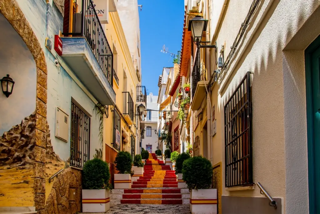 Spanish flag steps in a narrow street in Calpe Old Town