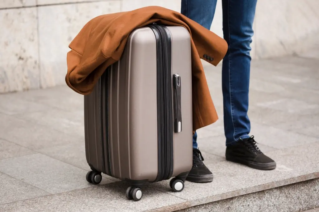 Traveller with a wheeled suitcase, illustrating the walk between Calp TRAM station and central Calpe with luggage