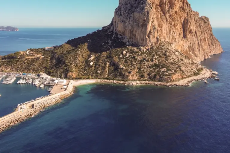 Aerial view of Paseo Princesa de Asturias beneath the Peñón de Ifach in Calpe, beside the marina and coastline