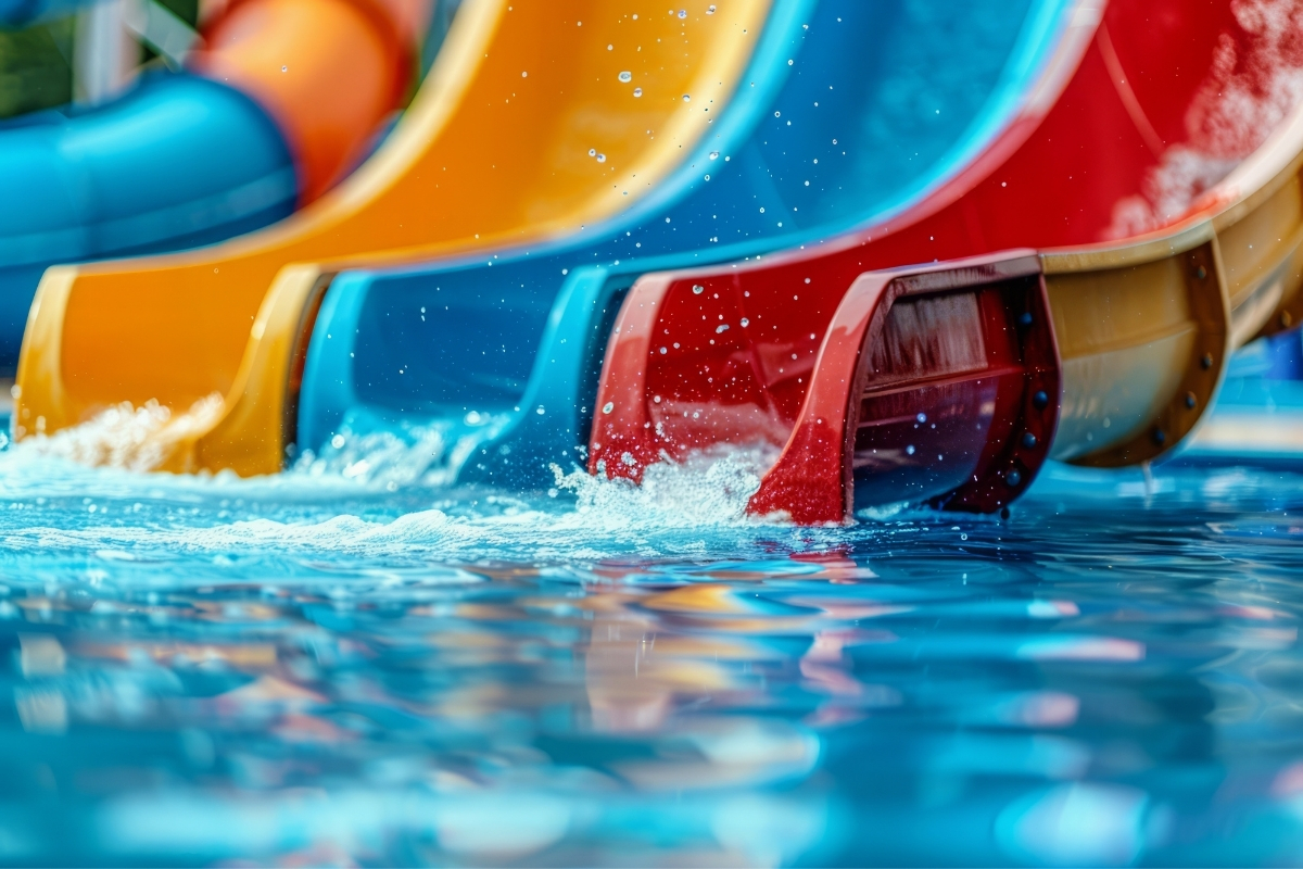 Colourful water slides emptying into a swimming pool at a water park near Calpe
