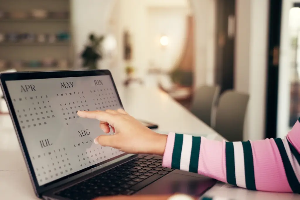 Person checking an online calendar while booking an NIE appointment from Calpe