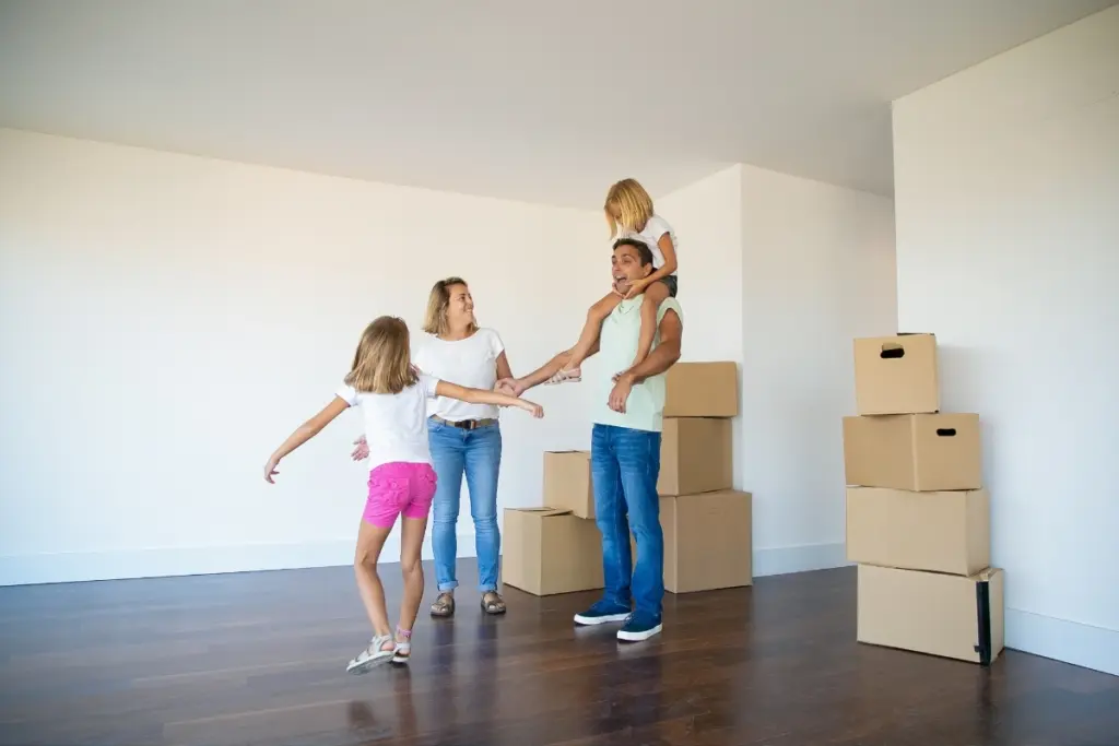 Family settling into a new apartment with moving boxes.