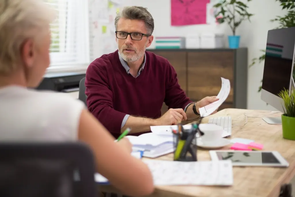 Client discussing NIE application paperwork with a professional adviser