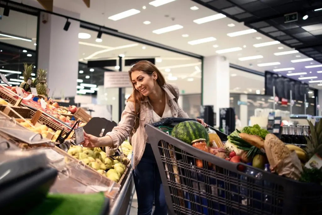 Woman shopping for fresh fruit and vegetables in a supermarket